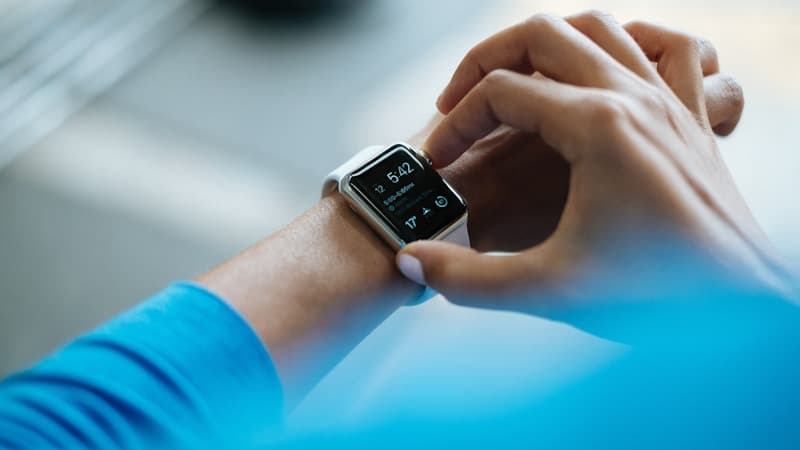 Oura ring beside a phone showing six months of sleep and readiness score trends